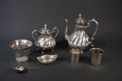 several pieces of silver are arranged on a black surface