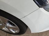 a close up of a car ' s headlight and front bumper