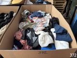 a cardboard box full of clothes sitting on top of a table