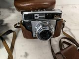 a brown camera with a brown strap on it