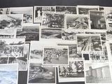 plusieurs photographies en noir et blanc représentant des personnes et des bâtiments, posées sur une table