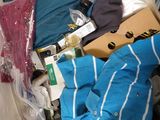 a pile of clothes and other items on a bed