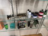 a glass shelf filled with various types of beauty products