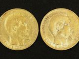 two gold sovereigns, one of which has a head of a man and the other of a woman