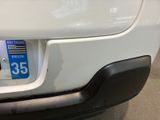 a close up of a white car with a number plate on it