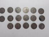 a close up of a bunch of coins on a white surface