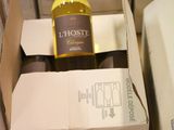 a bottle of wine sitting in a box on the floor