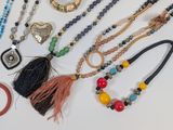 a lot of different necklaces and bracelets on the table