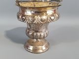 un vase en argent posé sur une table