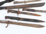 a lot of old knives that are on the table