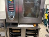a small oven that is sitting on a stand in a kitchen