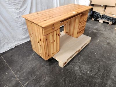 a desk made out of wood with a drawer underneath it