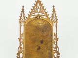 an image of a gold metal frame with a cross on it