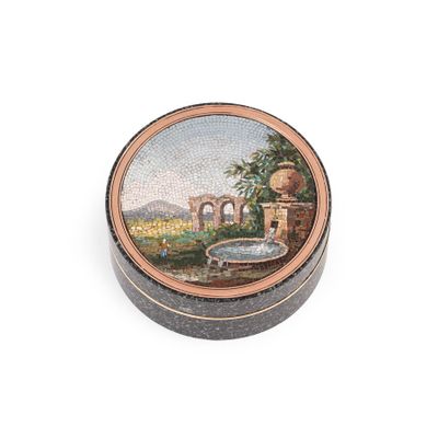 a small box with a painting on it on a white surface