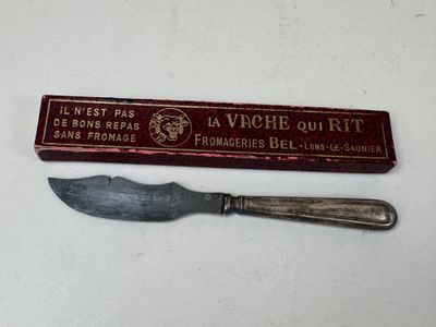 a knife that is sitting next to a box