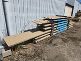 many pieces of wood stacked up on the ground