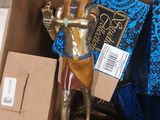 a statue of an egyptian man holding a book in a box