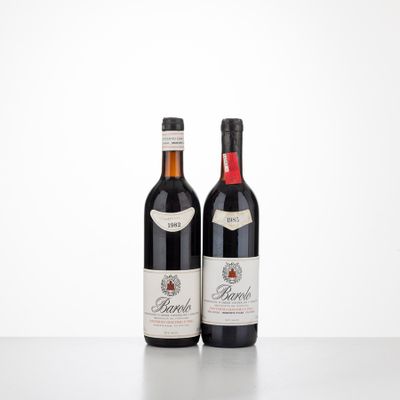 two bottles of wine sitting on top of a table next to each other