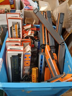 a blue container filled with assorted items in a room