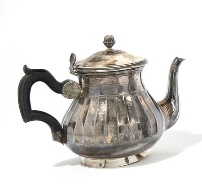 a silver teapot with a black handle on a white surface