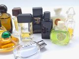 many different types of perfume bottles on a white surface