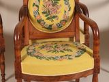 two wooden chairs with a yellow cushion and a yellow cushion on them