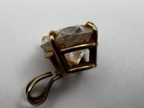 a close up of a piece of jewelry on a white surface