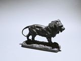 a statue of a lion that is standing on a table