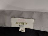 a close up of a label on a shirt that says modesty