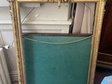 a picture of a gold frame with a picture on it