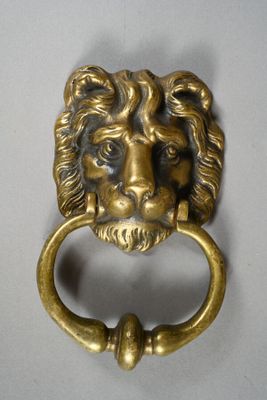 an image of a lion head door knocket on a white background