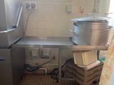 a kitchen with a sink and a large pot on the counter
