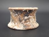 a close up of a small vase on a table