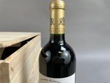 a bottle of wine sitting next to a wooden box
