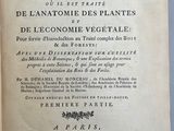 un vieux livre à l'écriture noire posé sur une table