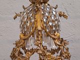 a gold chandelier hanging from a white wall