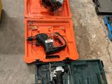 a tool box with a drill and other tools on the floor