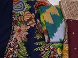 a lot of different types of cloths on a bed