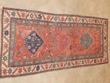 an old rug hanging on a wall in a room