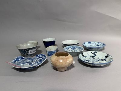 many different bowls and cups sitting on a table