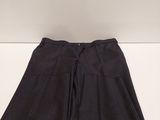 a pair of black pants sitting on top of a white table