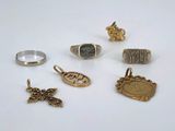 several different types of rings and pendants on a white surface