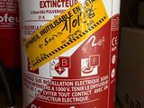 a fire extinguisor on the table next to a microwave