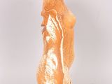 a gold statue of a woman standing on a white surface
