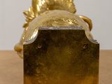 a gold fish statue sitting on top of a wooden table