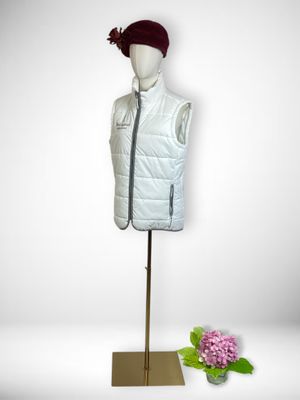 the mannequin is wearing a white vest and a red hat