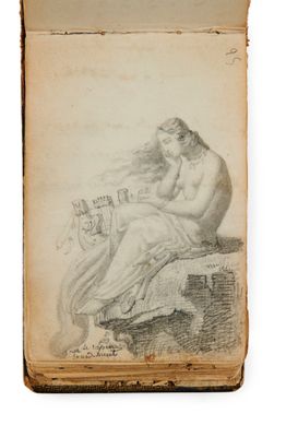 un vieux livre sur lequel figure le dessin d'une femme assise sur un rocher