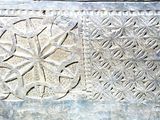 a close up of a stone carving with a flower design on it