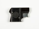 a close up of a black gun on a white surface