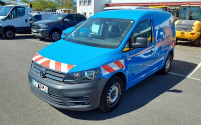 a blue van that is parked in a parking lot